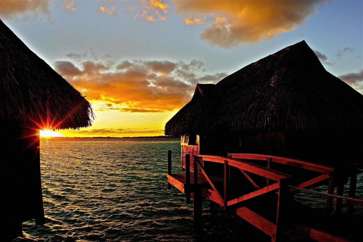 Sunrise over the calm Bora Bora lagoon with Otemanu silhouette, French Polynesia